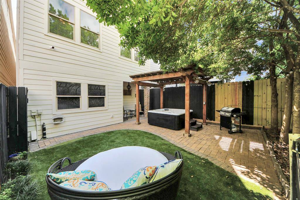 backyard with stone walkway and turf
