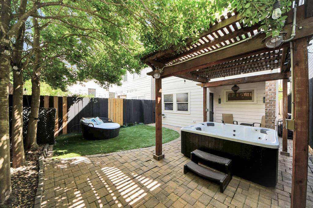 backyard with stone walkway and turf