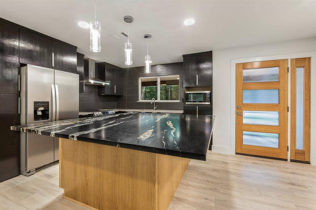 The gourmet kitchen features a gorgeous island with plenty of space seating. Discover additional storage underneath.