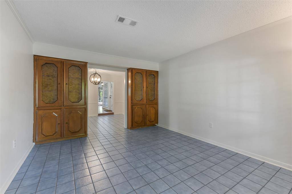 “Versatile library room with tile flooring—ideal for a home office or study.” 1st Floor