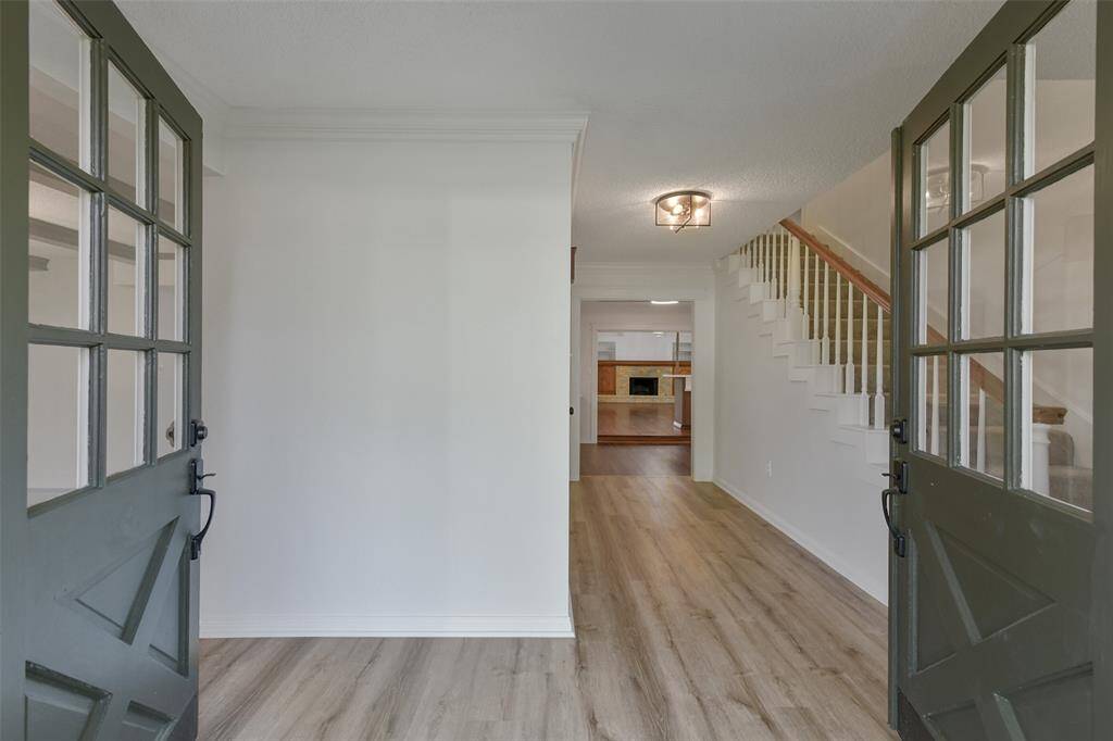 “Grand double doors lead into a welcoming foyer with brand new LVT flooring.”