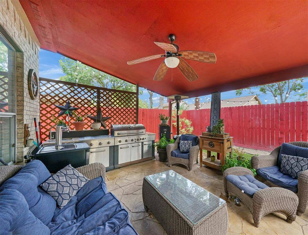 The outdoor covered patio area. All furniture and cooking appliances have been removed.