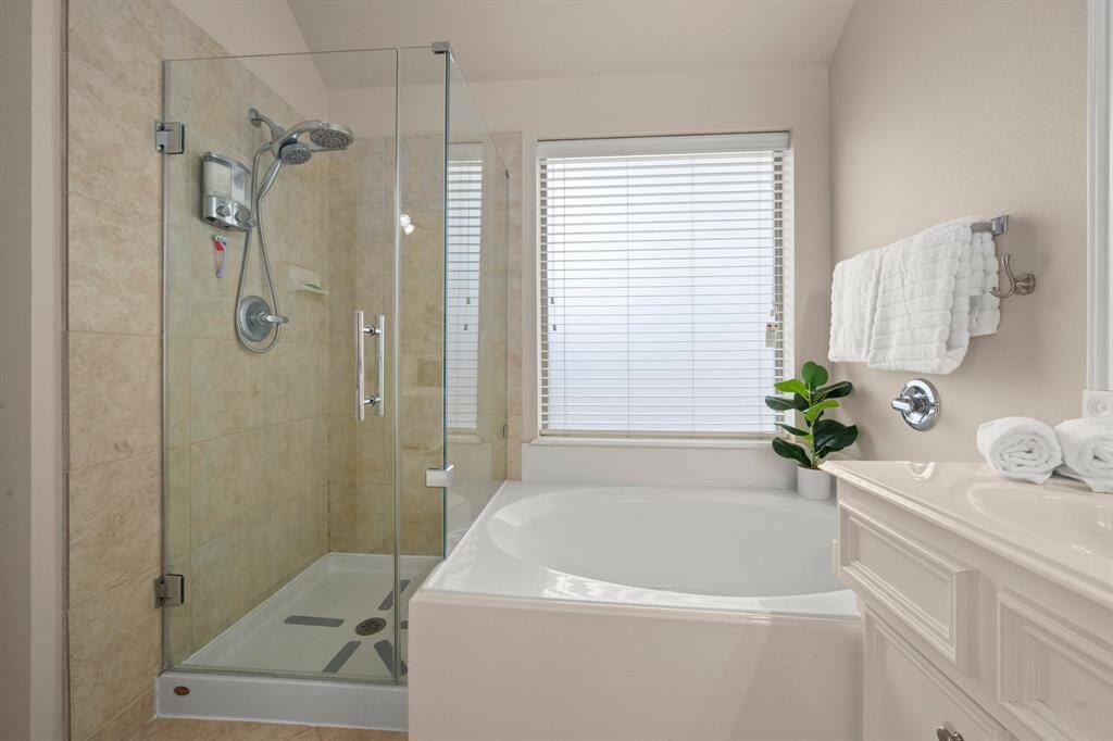 Ensuite bath includes double sinks, a garden tub, and a new frameless glass shower.