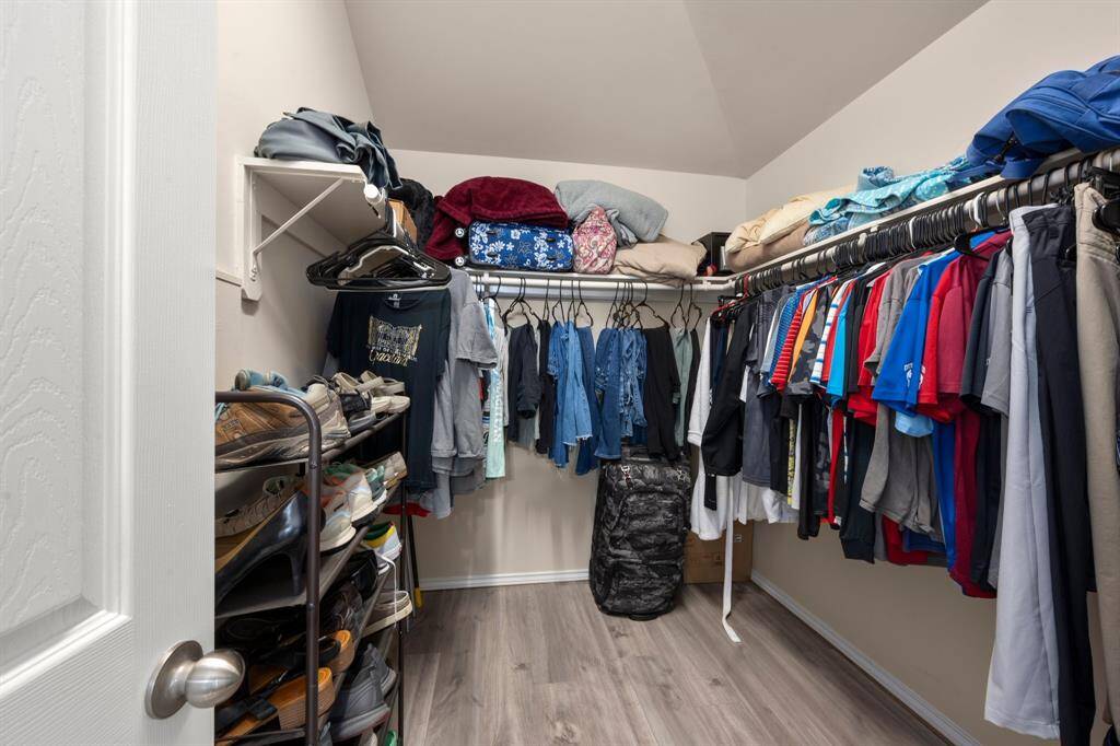 Walk-in closet offers plenty of storage and convenience.