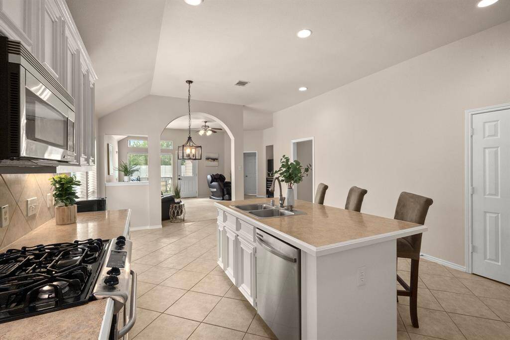 Painted cabinets and under-cabinet lighting add charm to the kitchen.