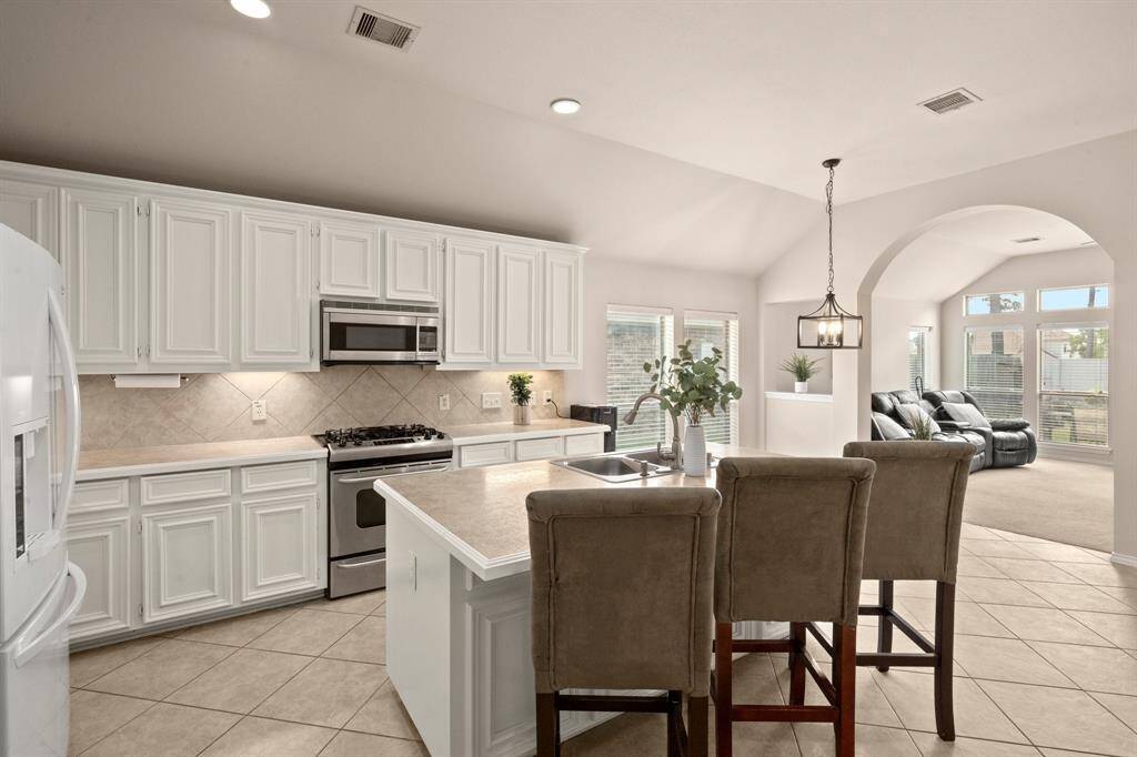 Eat-at breakfast bar connects to the dining area and living room.