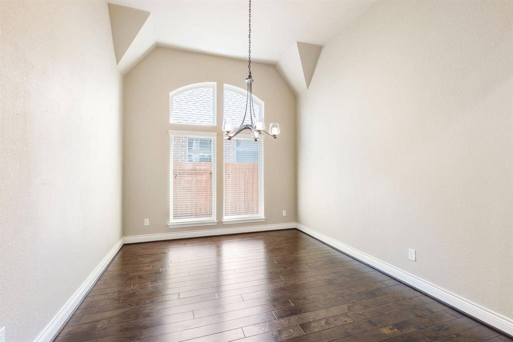 Wood floors compliment light neutral walls in this formal dining.