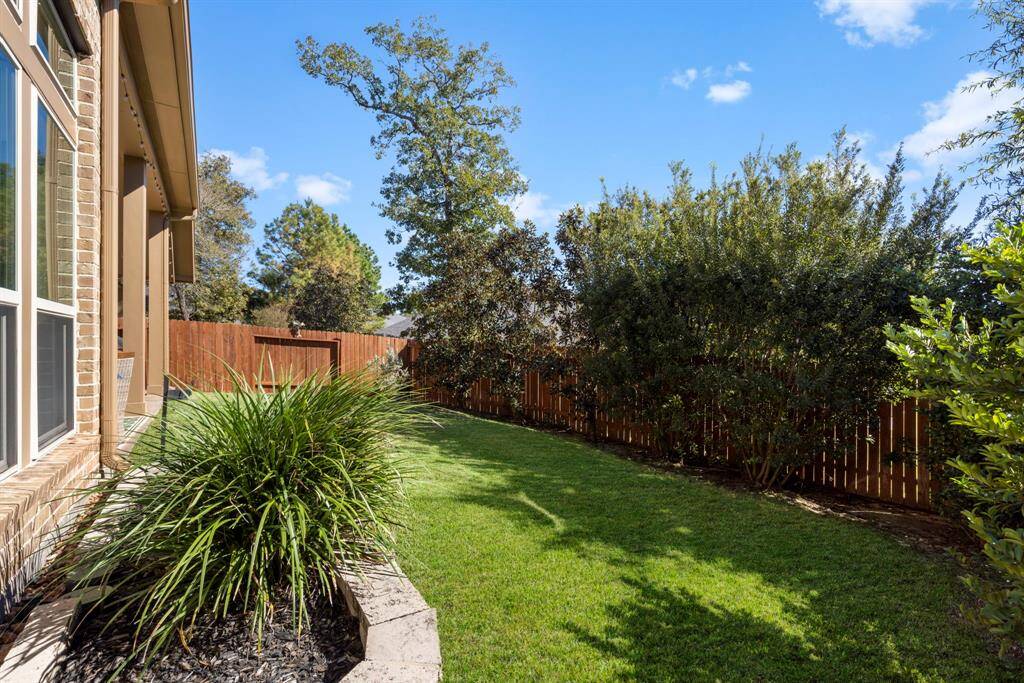 Backyard highlights a recent (2024) stained fence.