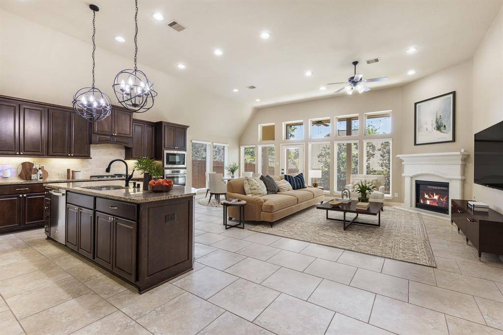 Designed for effortless entertaining, the kitchen seamlessly opens to the cozy breakfast area and inviting family room, creating a warm and connected living space. (Virtually staged inspirational photo.)