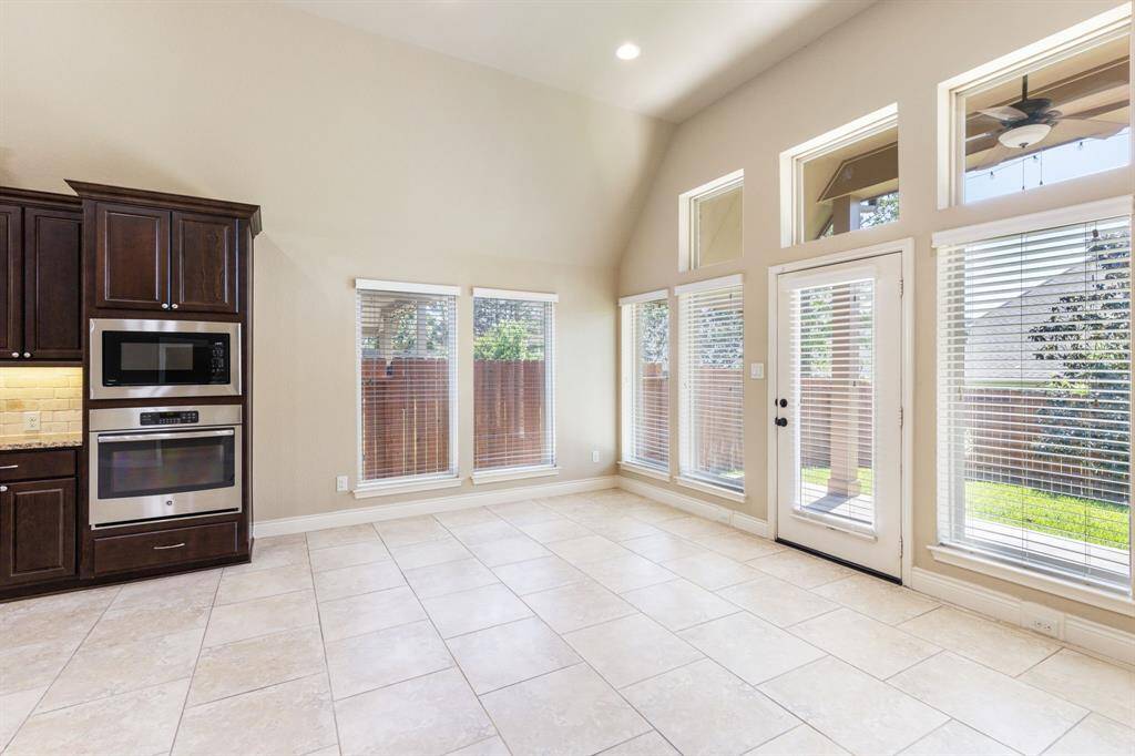 Along the back of the home, transom and picture windows showcase beautiful views while filling the space with soft, natural light and enhancing the home's open, airy feel.
