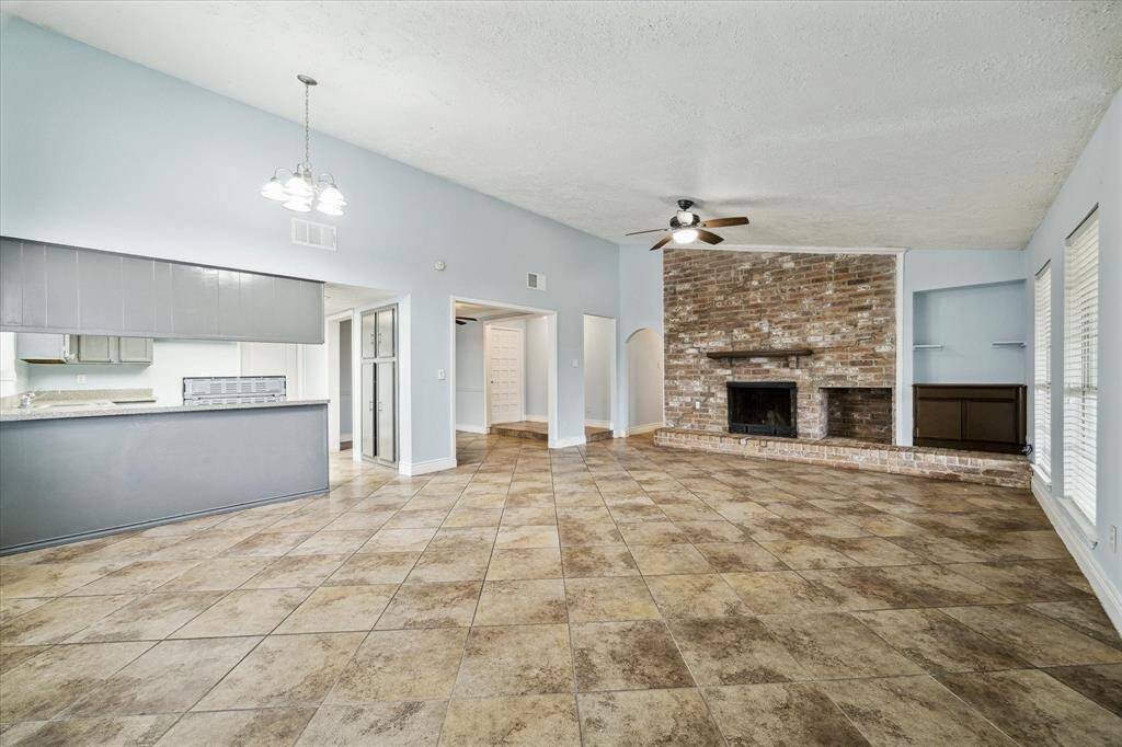 The fireplace and built ins are a great bonus along with the high ceilings and tile floor.