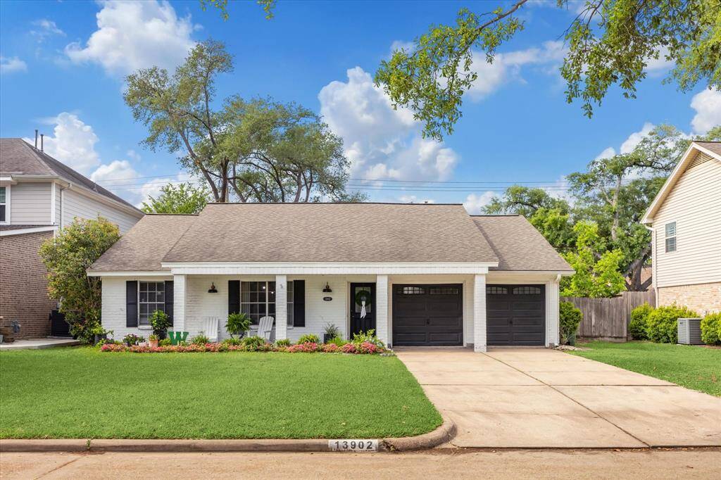 A welcoming front porch and lush, low-maintenance landscaping create instant curb appeal for this inviting home.
