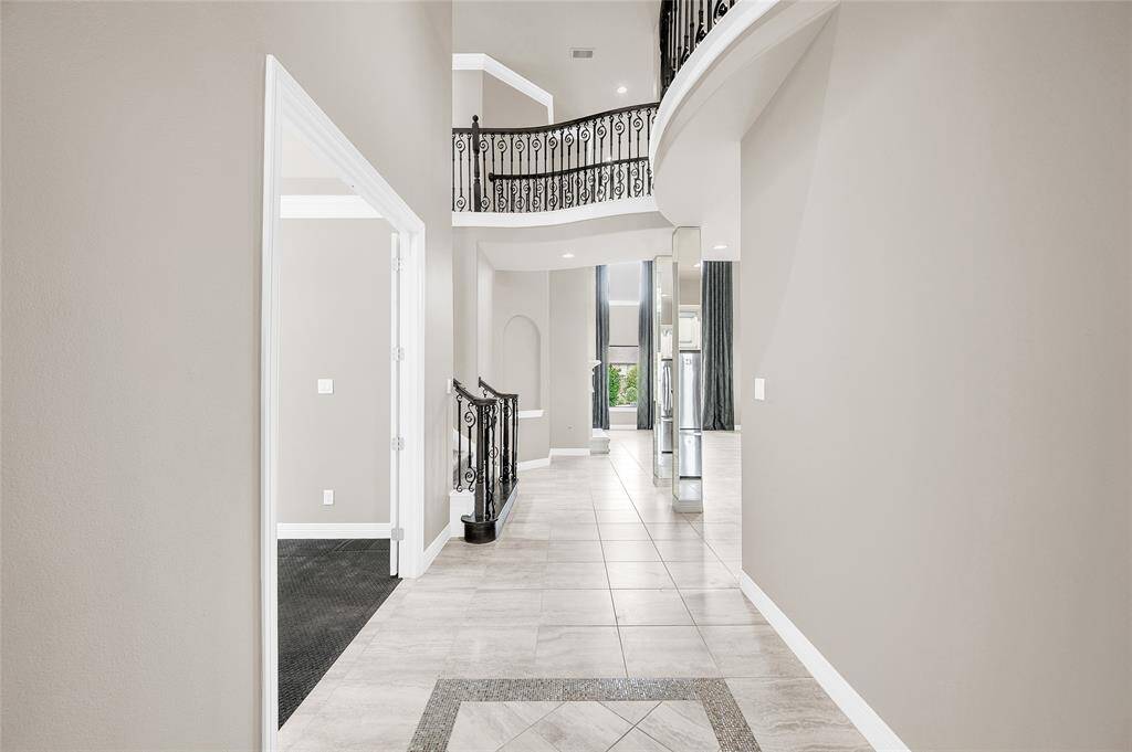 Open view from the foyer seamlessly flows into the home office/study and den.