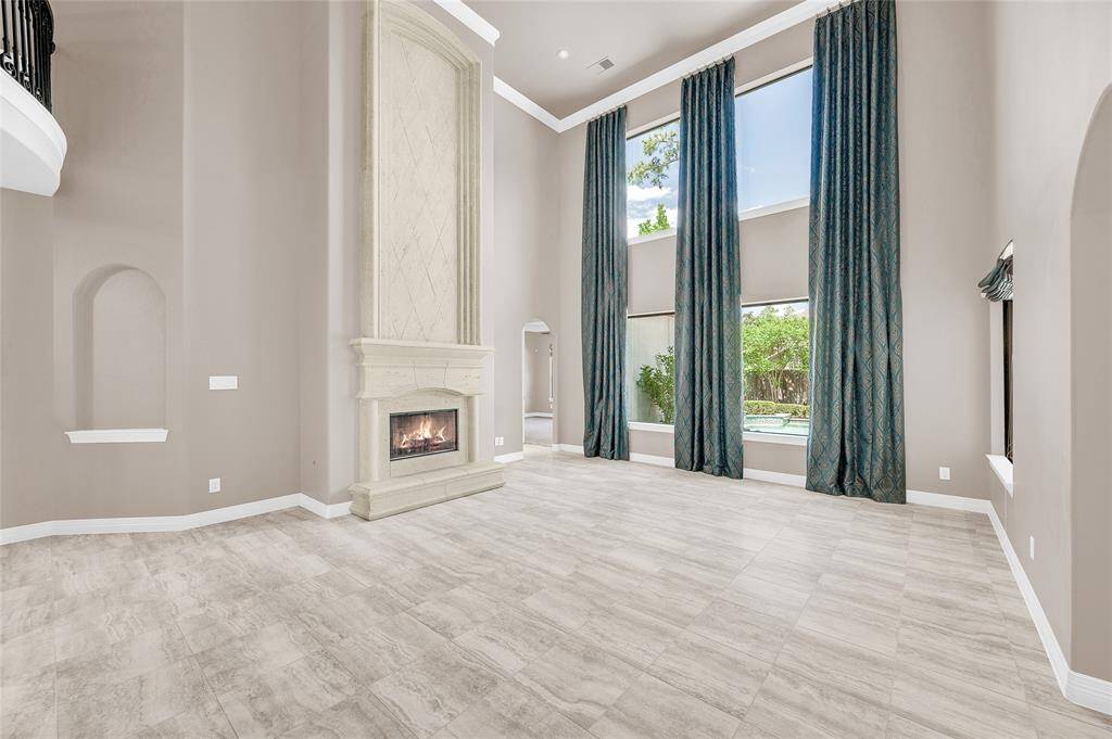 The den boasts 25-foot ceilings with open views overlooking the second level.