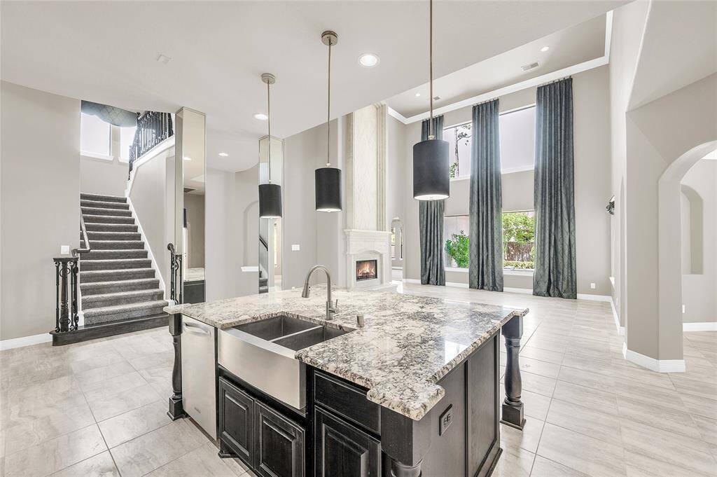 The kitchen opens to the den, offering views of the backyard pool.