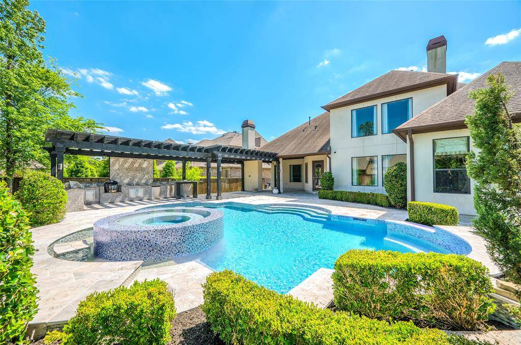 A backyard paradise featuring a custom-designed in-ground pool.