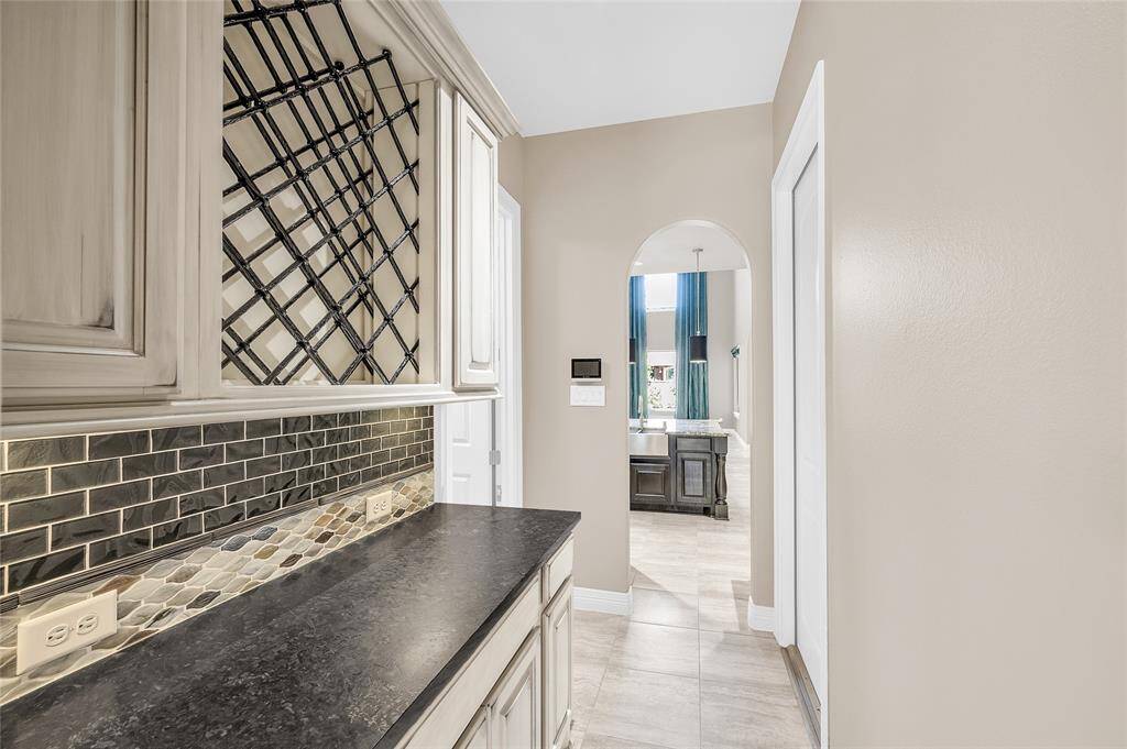 Butler's pantry featuring a custom wrought iron wine rack