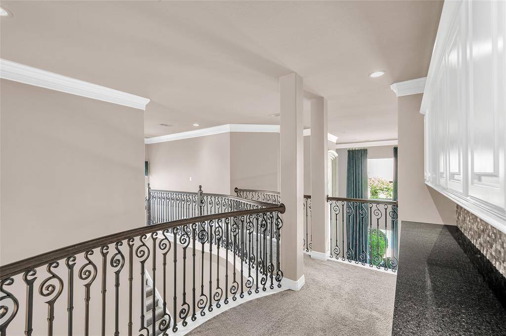 The secondary level overlooks both the foyer and den.