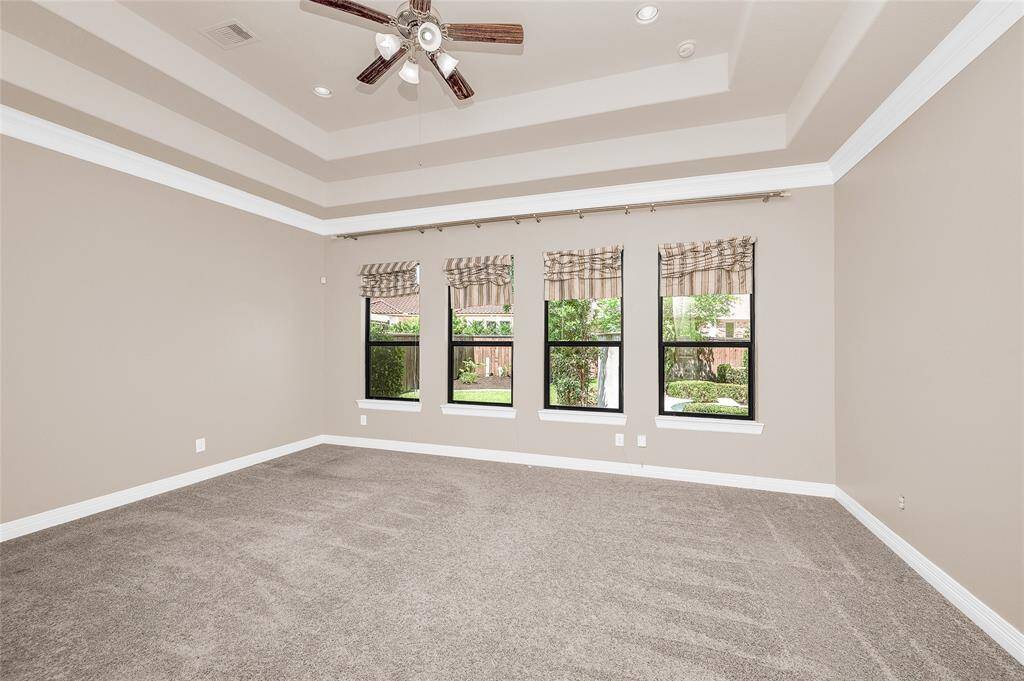 Primary bedroom suite offering stunning views of the backyard.