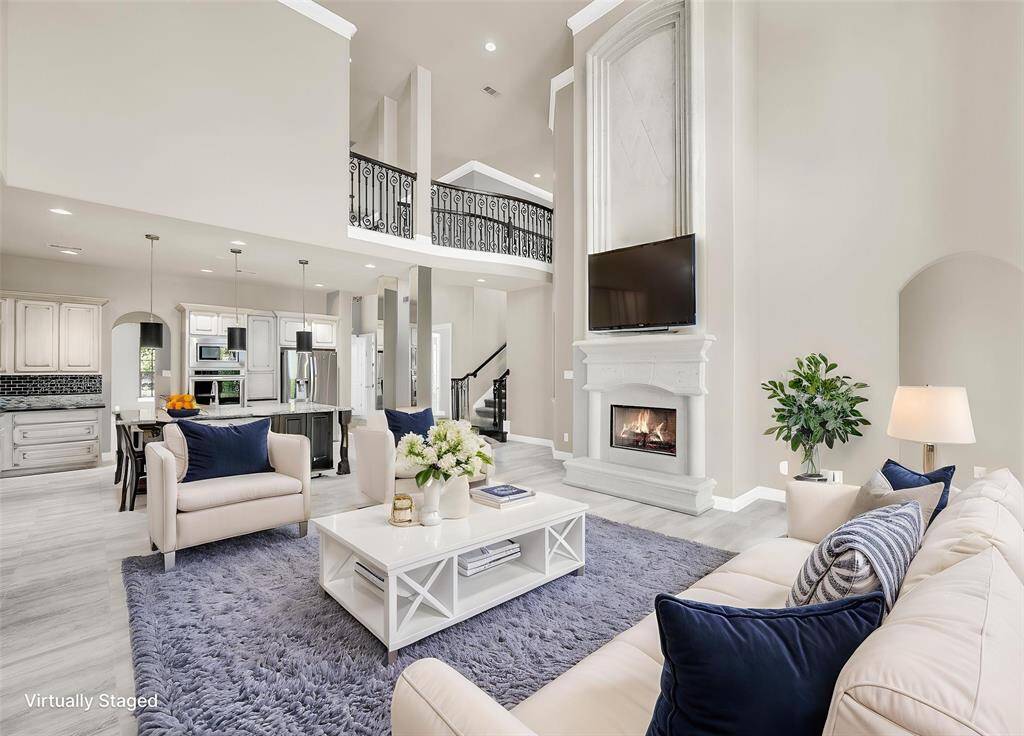 Expansive den with stone-cast floor-to-ceiling fireplace.