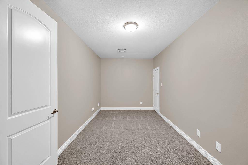 Versatile flex room ideal for a workout space, playroom, craft area, or additional storage.