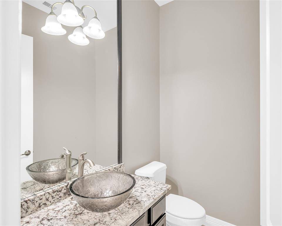 Half bath with convenient access under the covered back patio, perfect for poolside clean-up.
