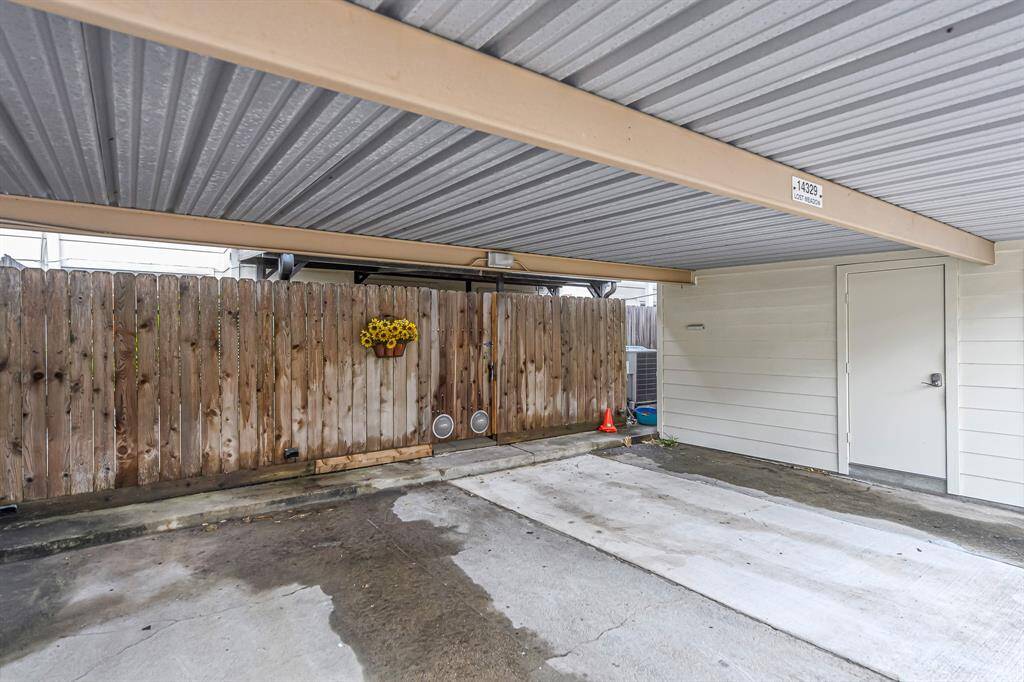 Two covered parking spaces & an oversized outdoor workshop/storage area