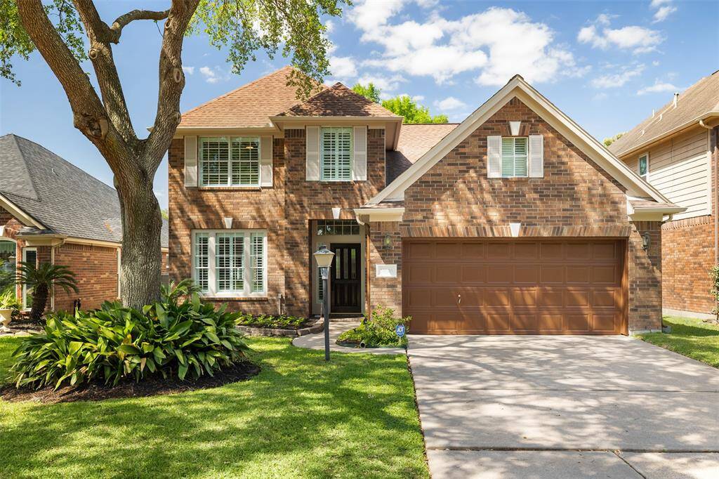 Gracefully situated in a gated community, this stately two-story home blends traditional architecture with beautifully maintained landscaping and timeless curb appeal. A mature shade tree anchors the front yard, while classic shutters and a two-car garage complete the picture of refined suburban living.