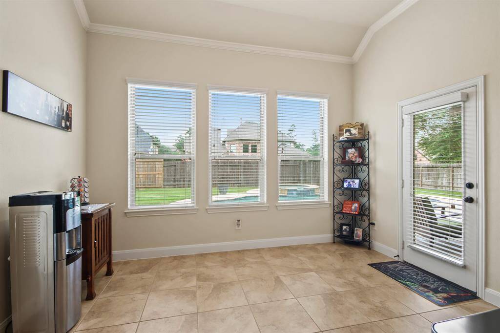 Breakfast area with view of pool and backyard.