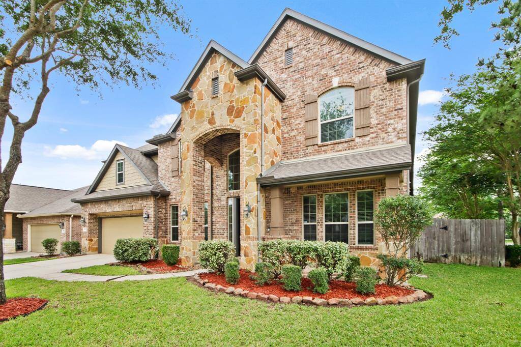 This is a beautiful two-story brick and stone is located in a serene neighborhood, offering traditional elegance and curb appeal.