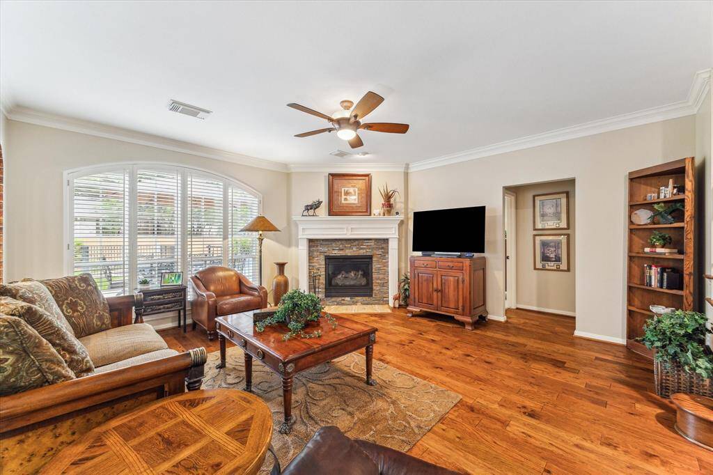 The family room is anchored by a gas log fireplace and overlooks the back yard. Plantation shutters grace the home throughout. Thick storm windows withstand storms, reduce outside noise and provide an extra layer of security as well as a thermal barrier from the elements.