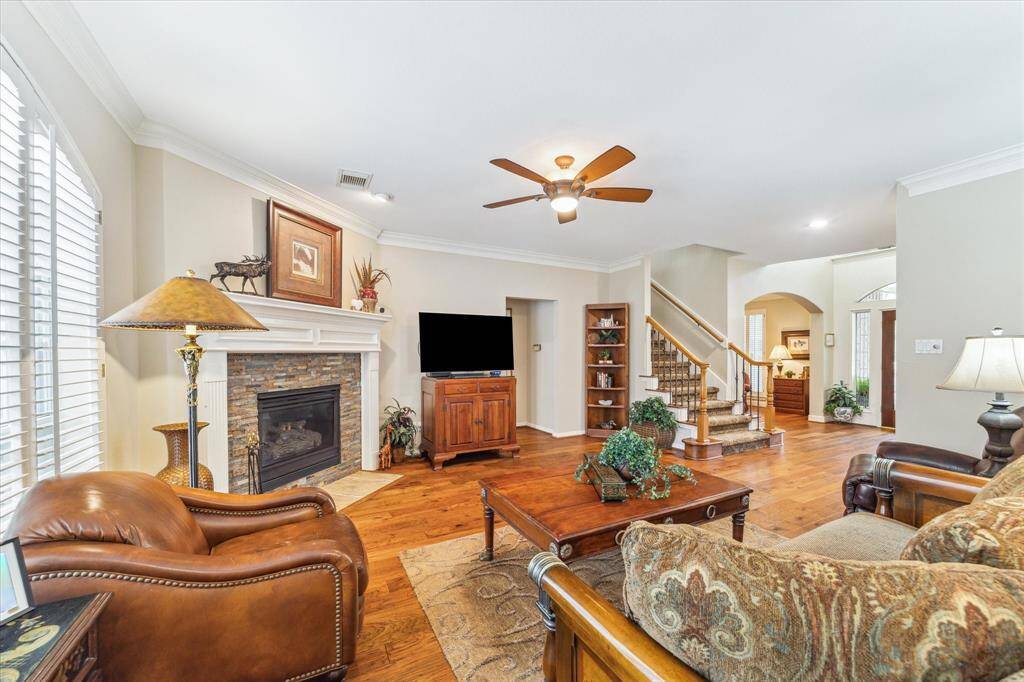 This is the view of the family room from the kitchen. To the left of the stairs is the entrance to the primary suite.