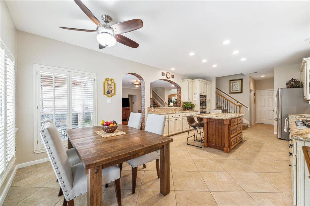 Enter the large kitchen from the back door and this is what awaits you! A large breakfast area is well lit with natural light. The kitchen is open to the family room and features premium granite counter tops. Abundant cupboards, stainless appliances including double ovens, a five burner cooktop, and a custom island complete this chefs workspace.