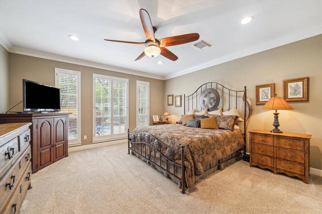 The expansive primary suite sits adjacent to the sparkling pool with tanning steps and spa.