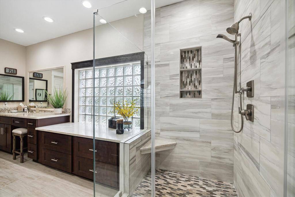 The other side of the primary bathroom. The sellers removed the tub and installed more storage space. However, if you prefer a soaking tub, they left the plumbing in place for you.