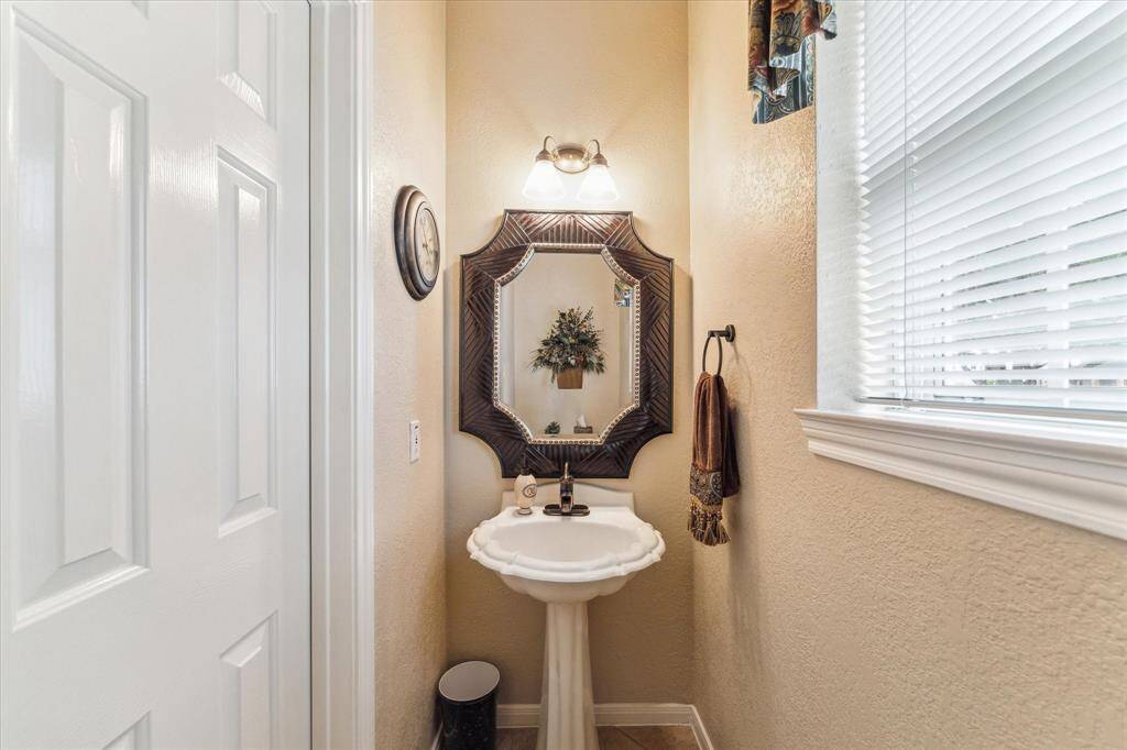 The powder room on the first floor is convenient to back door. The tile flooring in the kitchen makes access from your pool guests possible without fear of moisture damage.