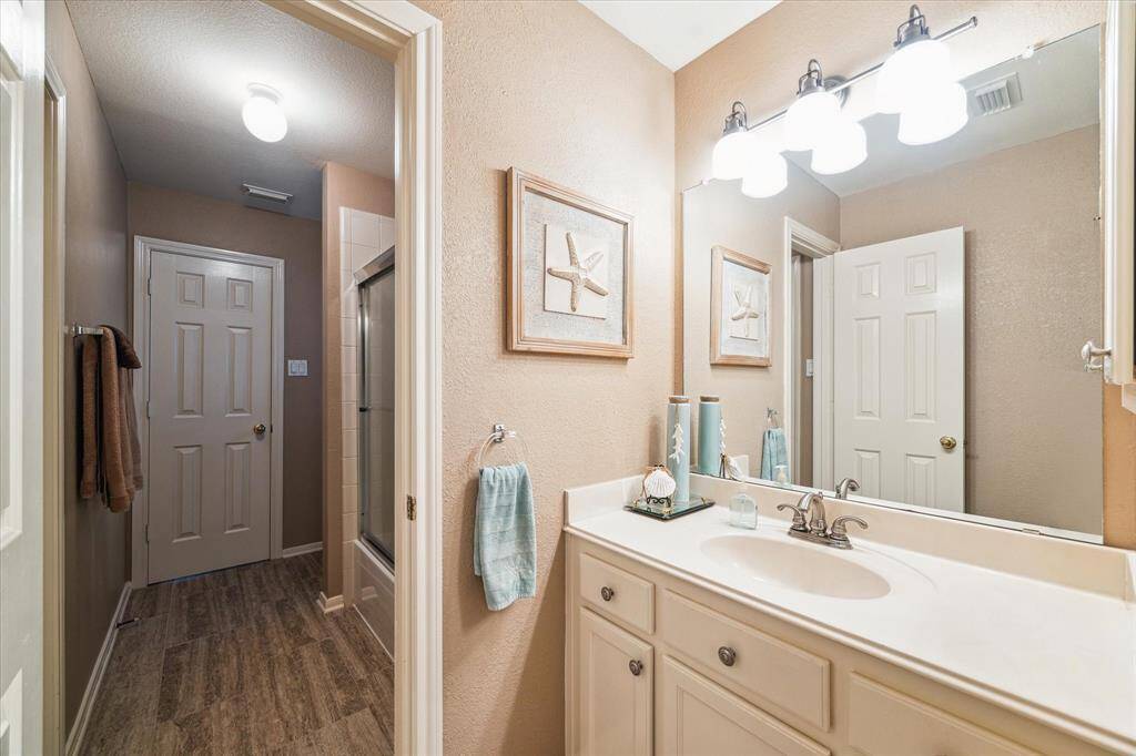 Each bedroom has a private sink. The toilet and tub/shower combination are located between the vanity areas.