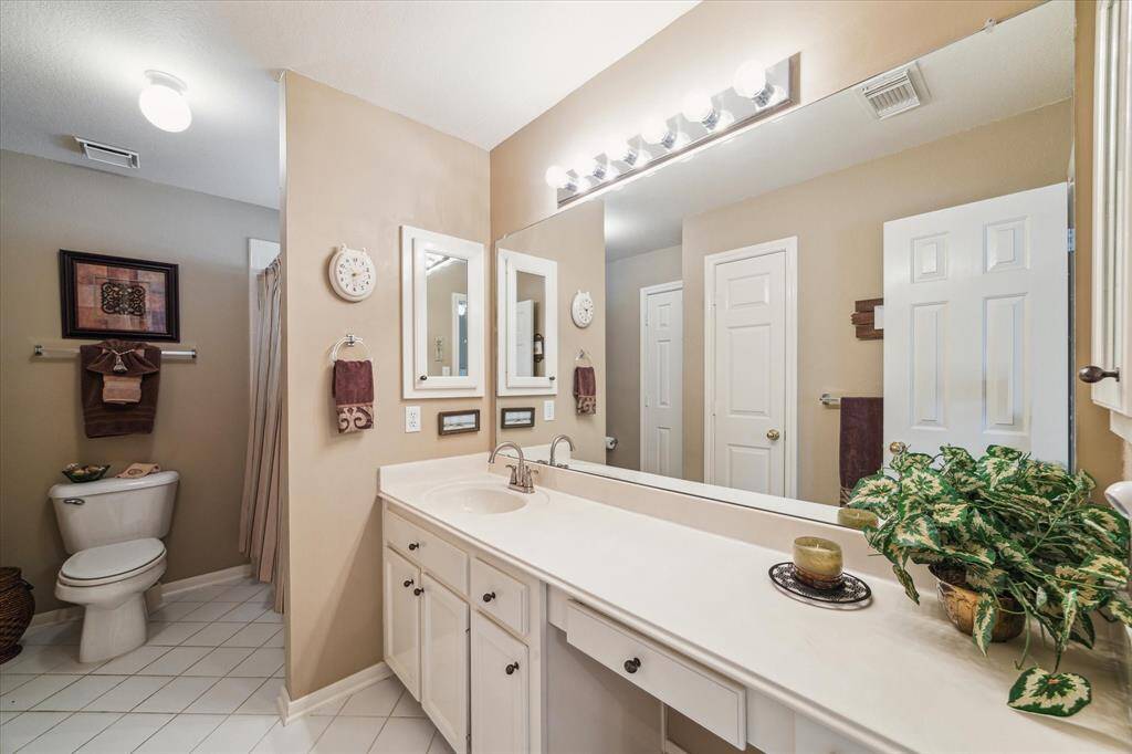 This bathroom separates the bedrooms on the other side of the game room.