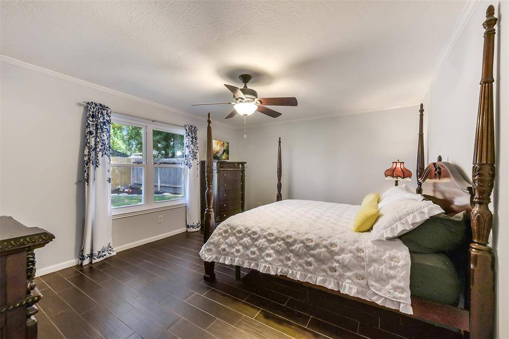 Primary bedroom with wood look tile.