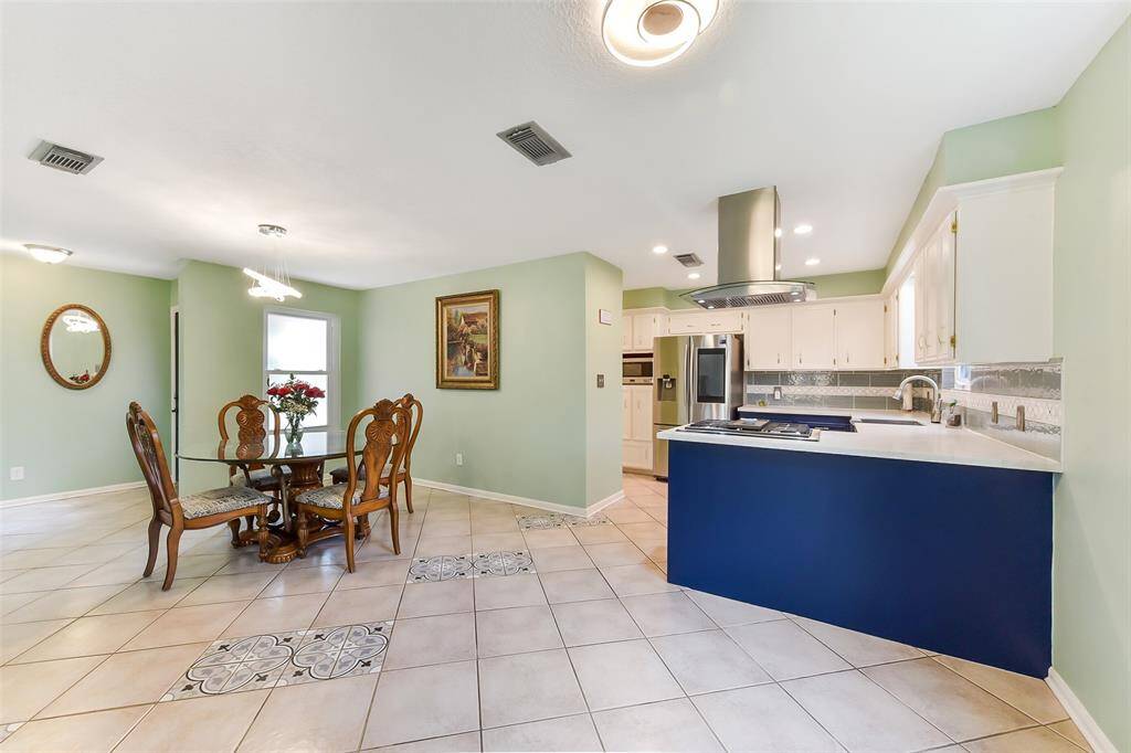 The kitchen has been beautifully updated with stainless appliances and upper and lower cabinets.