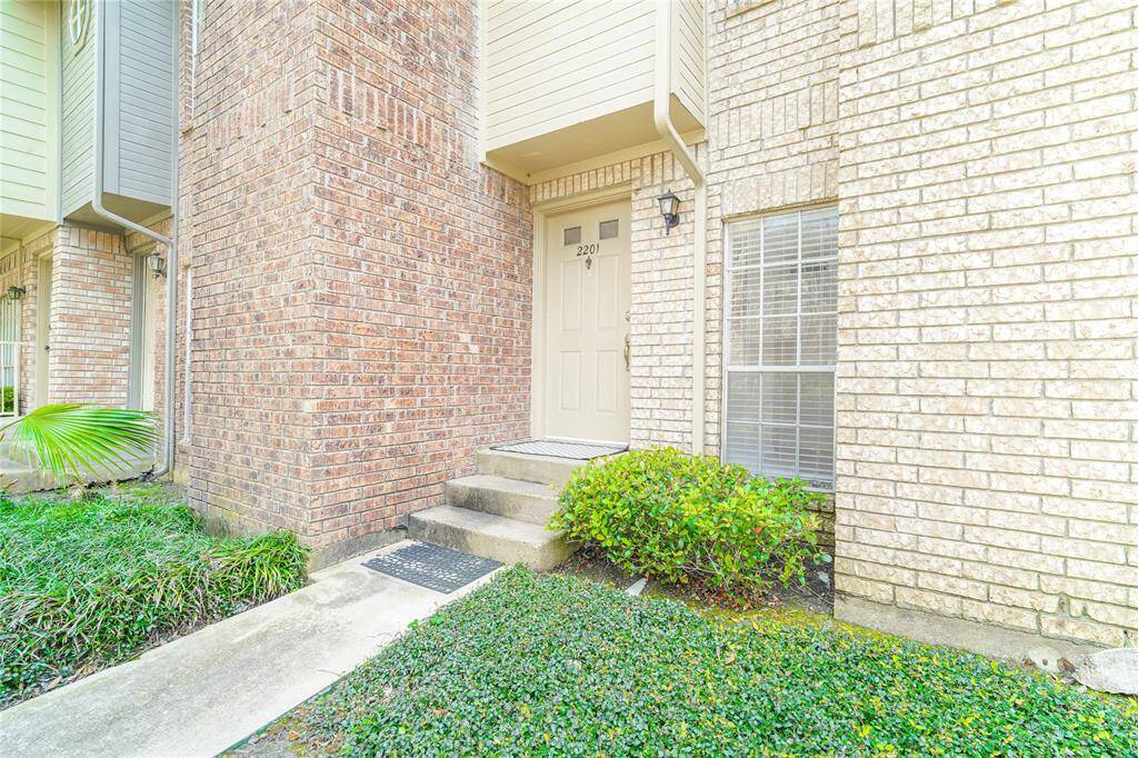 A welcoming front door, with lush green landscaping, creating a vibrant and inviting entrance.