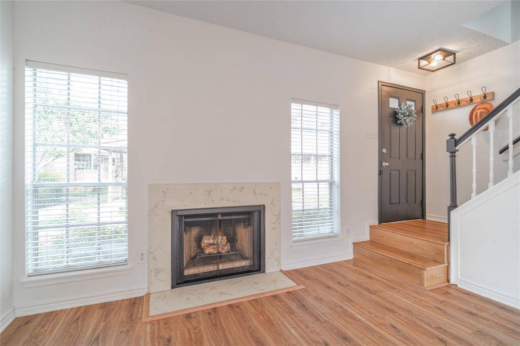 A cozy living room featuring a Wood-burning fireplace.