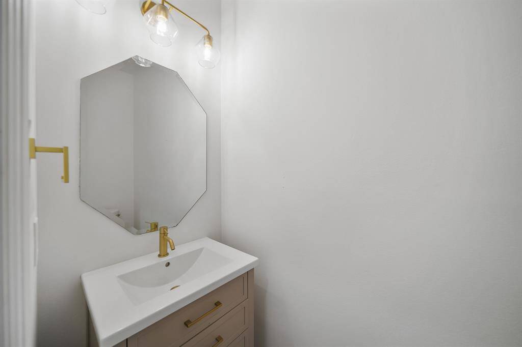 A conveniently located powder room offers a stylish space for guests and everyday use.