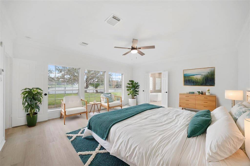 Wake up to breathtaking lake views through a stunning wall of windows that fill the primary bedroom with natural light.