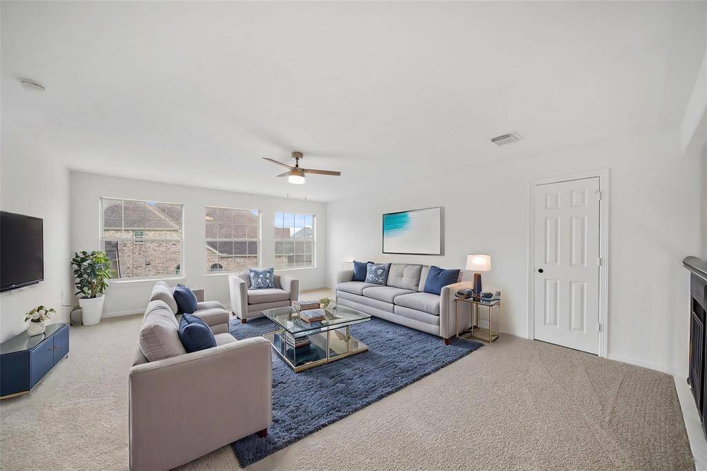 Large windows flood the space with natural light, creating a bright and inviting atmosphere perfect for gatherings or a play area.