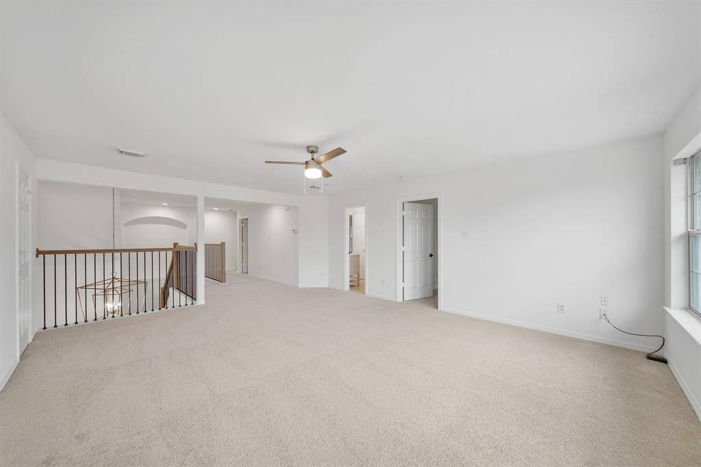 The game room features plush carpeted flooring, providing a cozy and comfortable space for entertainment and relaxation.