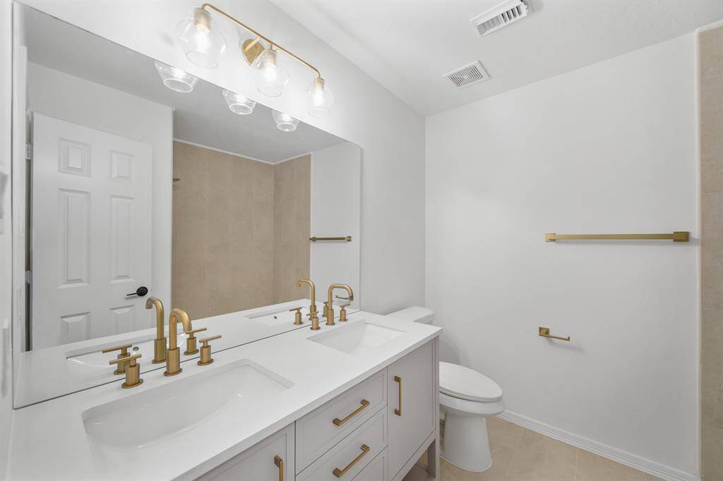 Designed for efficiency, this bathroom includes a spacious walk-in shower for a refreshing experience.