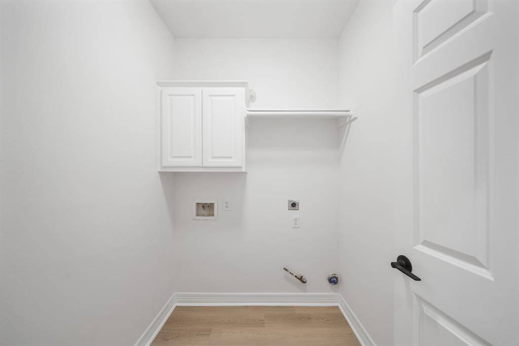 A well-organized laundry room featuring a cabinet and a convenient hanging rack offers both functionality and style