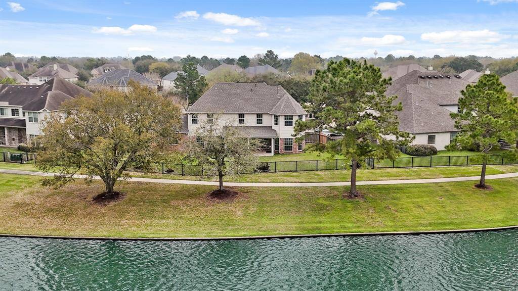Enjoy the breathtaking beauty of a tranquil lake right in your backyard, creating a peaceful and relaxing atmosphere.