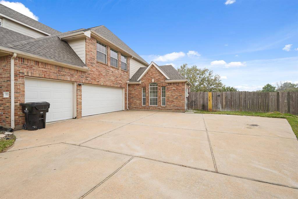 This property features a convenient three-car attached garage and an oversized driveway, perfect for additional parking or guest access.